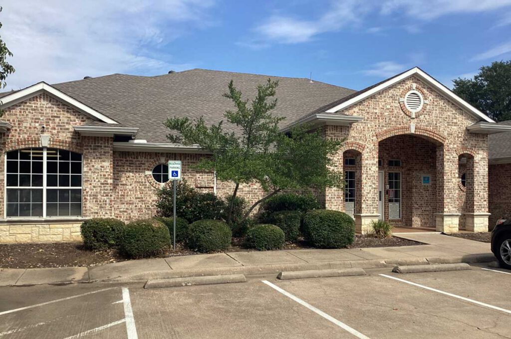 Exterior entrance of the Bright Mosaic Autism Center in Southlake, a brick facility providing ABA Therapy, Speech Therapy, and OT services with accessible parking and professional landscaping.